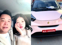 Ton Bang shows off a Porsche supercar gifted to his young wife; the inverted logo sparks speculation that it's a hybrid electric vehicle.